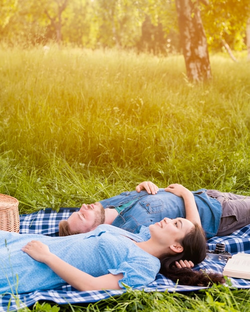 Free Photo young attractive couple relaxing on picnic in nature