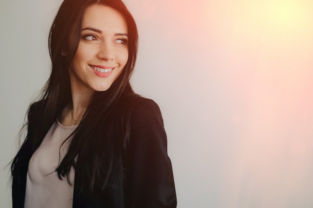 Free photo young attractive emotional girl in business-style clothes on a plain white background in an office or audience