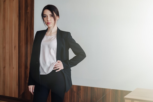 Free Photo young attractive emotional girl in businessstyle clothes o