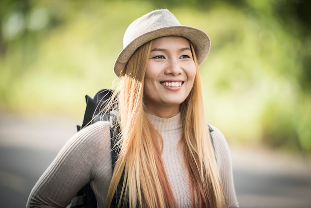 Young attractive woman backpack to traveling on her holiday. Woman lifestyle concept.