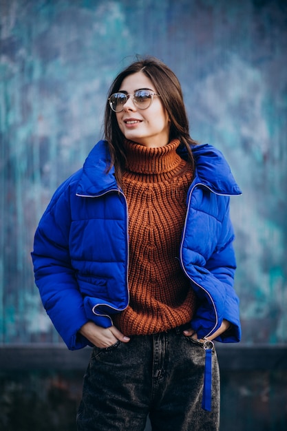 Young attractive woman in blue winter jacket