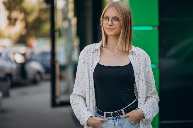 Free photo young attractive woman in street outfit