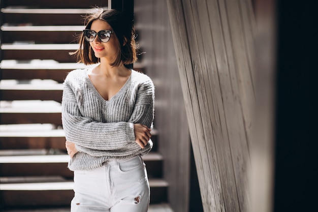 Free Photo young attractive woman in white denims outside the street