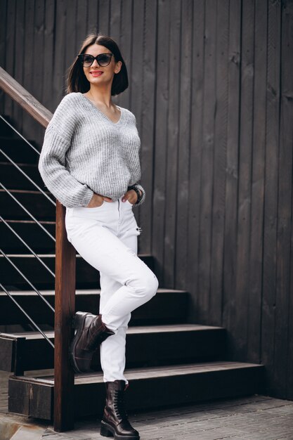 Young attractive woman in white denims outside the street