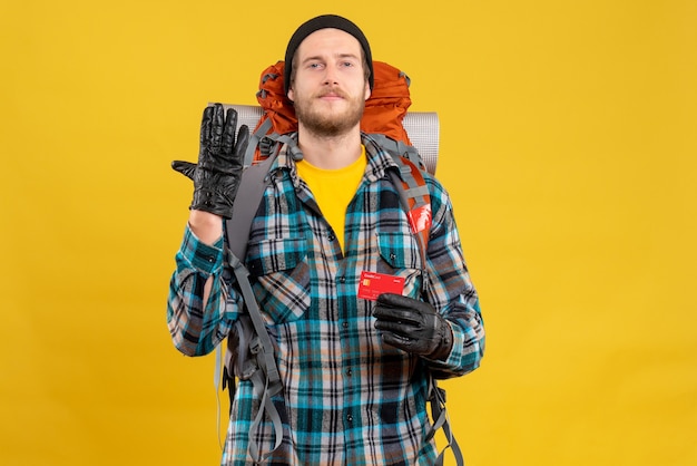 Free Photo young backpacker with black hat holding credit card