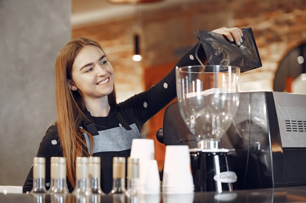 Free Photo young barista girl makes coffee and smiles