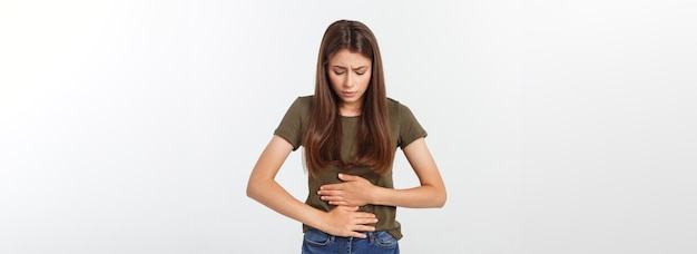 Free photo young beautiful asian woman having painful stomachache on white background