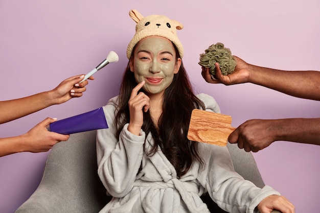 Free photo young beautiful asian woman wears moisturizing face mask, dressed comfortable