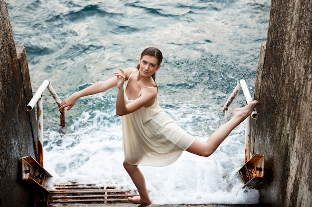 Free Photo young beautiful ballerina dancing and posing outside