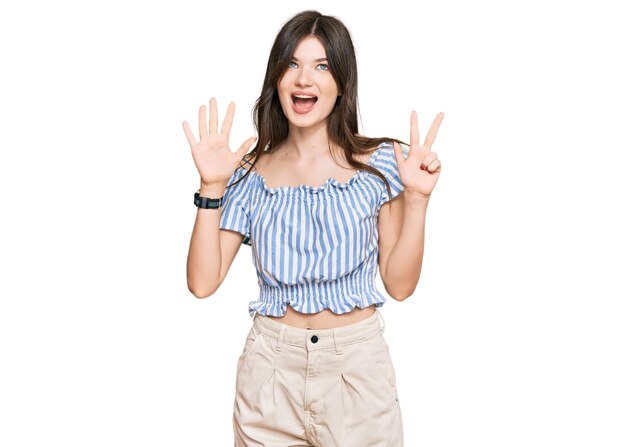 Young beautiful caucasian girl wearing casual clothes showing and pointing up with fingers number eight while smiling confident and happy.