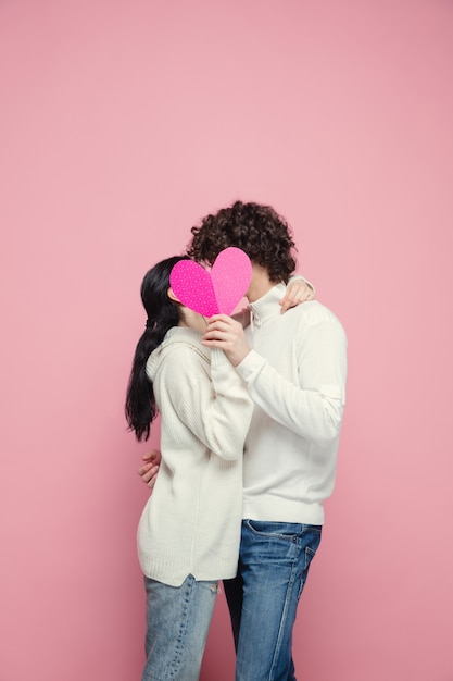 Free Photo young, beautiful couple in love on pink studio wall