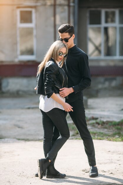 Young beautiful couple posing on old building