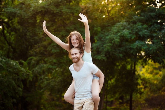 Free photo young beautiful couple resting, walking in park, smiling, rejoicing outdoors