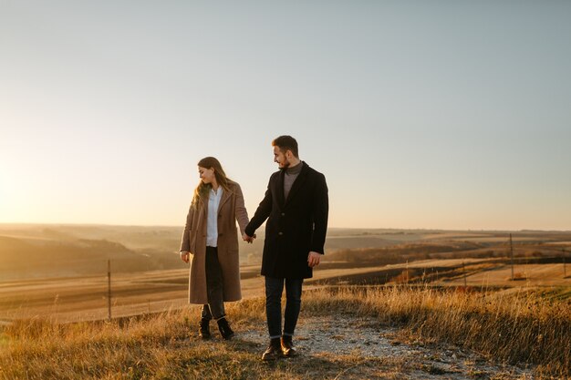 Young and beautiful  couple walking outdoors on a sunny day