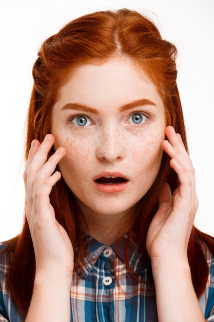 Free Photo  young beautiful ginger girl over white wall.