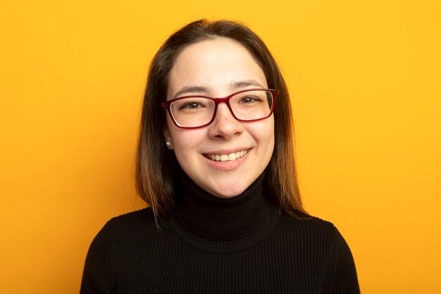 Young beautiful girl in a black turtleneck with smile on face 