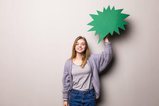 Young beautiful girl holding a yellow bubble for text, isolated