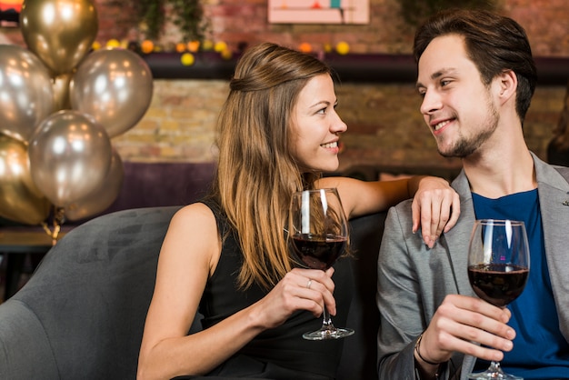 Free photo young beautiful happy couple enjoying their date at bar