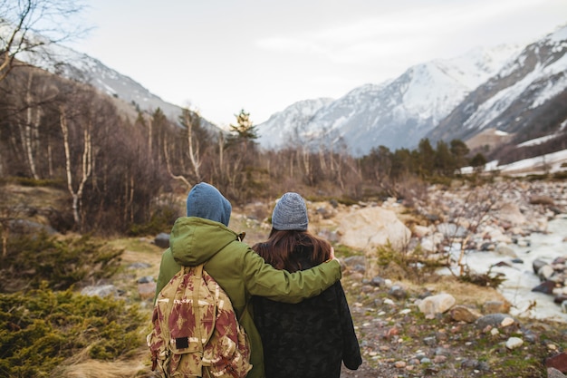 Young beautiful hipster man and woman in love traveling together in wild nature