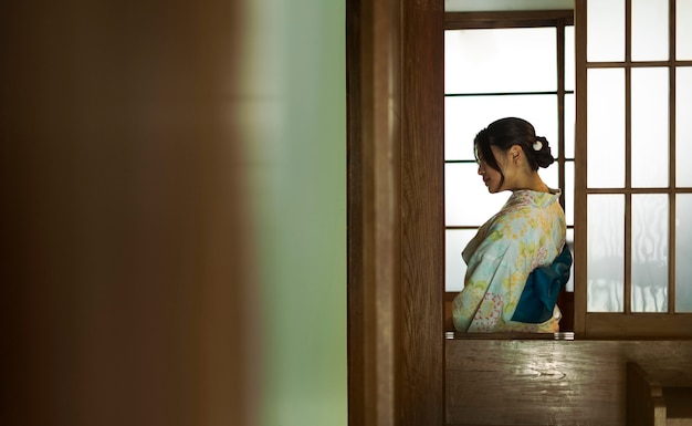 Young beautiful japanese woman wearing a traditional kimono