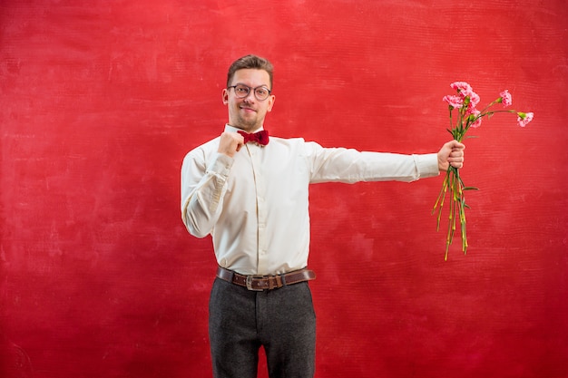 Free Photo young beautiful man with flowers