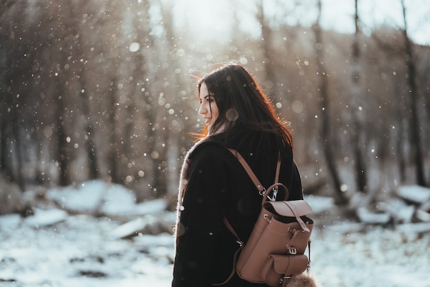 Young beautiful model posing in winter forest. stylish fashion portrait