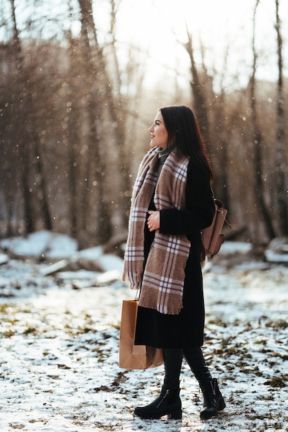 Free Photo young beautiful model posing in winter forest