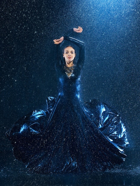 Free photo young beautiful modern dancer dancing under water drops