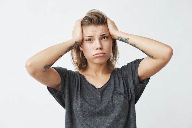 Free Photo young beautiful nervous upset girl thinking holding head .