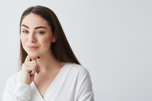 Young beautiful playful businesswoman with cunning tricky glance smiling .