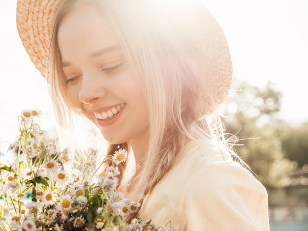 Young beautiful smiling hipster woman in trendy summer sundress