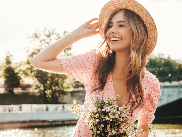 Young beautiful smiling hipster woman in trendy summer sundress