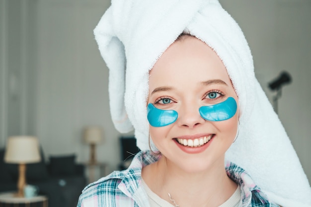 Free Photo young beautiful smiling woman with patches under eyes