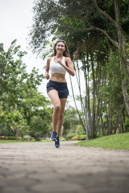 Young beautiful sport woman running at the park. Health and sport concept.