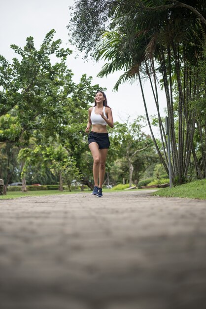 Young beautiful sport woman running at the park. Health and sport concept.