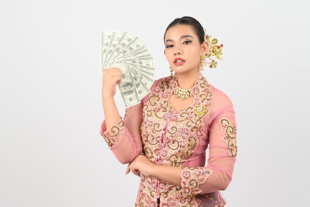 Young beautiful woman dress up in local culture in southern region pose with banknote