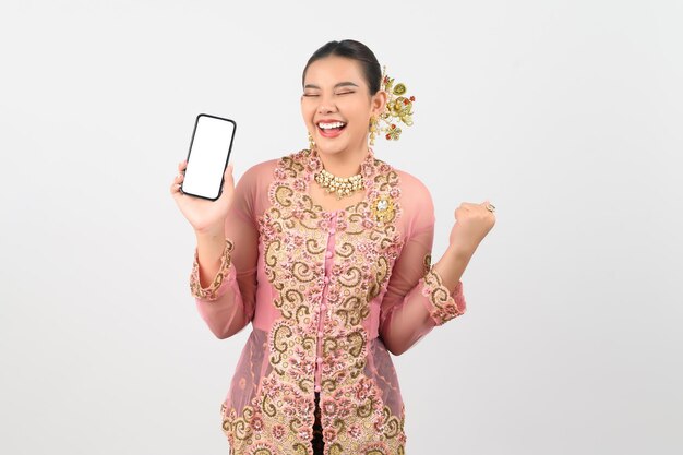 Young beautiful woman dress up in local culture in southern region pose with smartphone