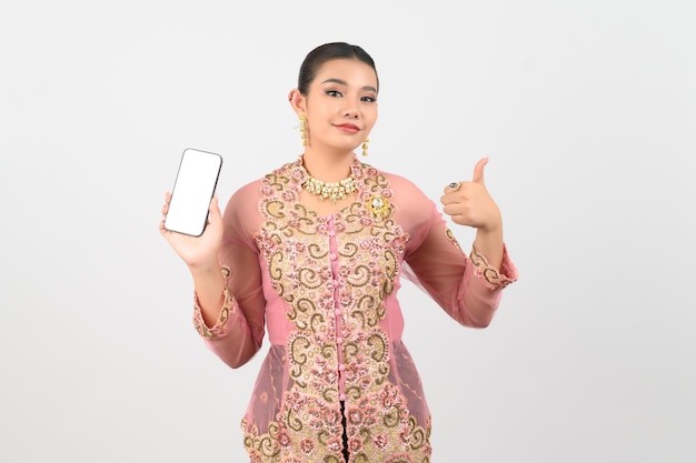 Young beautiful woman dress up in local culture in southern region pose with smartphone