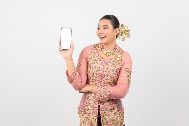 Young beautiful woman dress up in local culture in southern region pose with smartphone