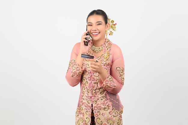 Young beautiful woman dress up in local culture in southern region pose with smartphone