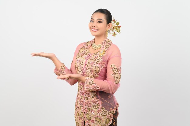 Young beautiful woman dress up in local culture in southern region presenting product posture