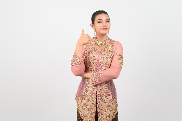 Young beautiful woman dress up in local culture in southern region and thumb up posture