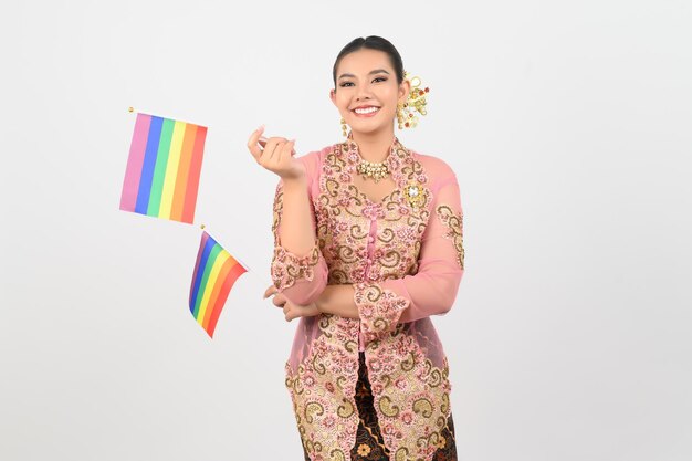 Young beautiful woman dress up in local culture in southern region with rainbow flag