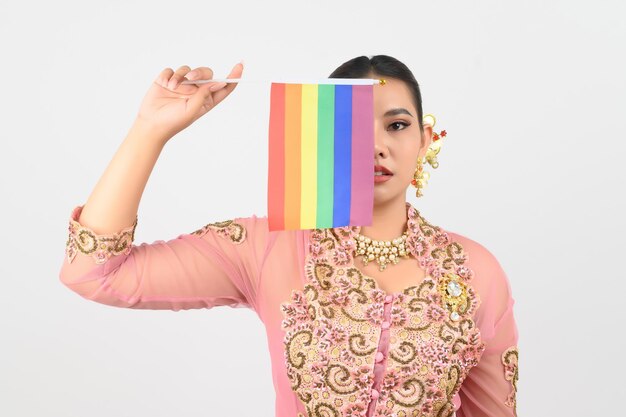 Young beautiful woman dress up in local culture in southern region with rainbow flag