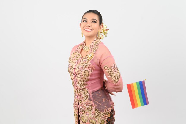 Young beautiful woman dress up in local culture in southern region with rainbow flag