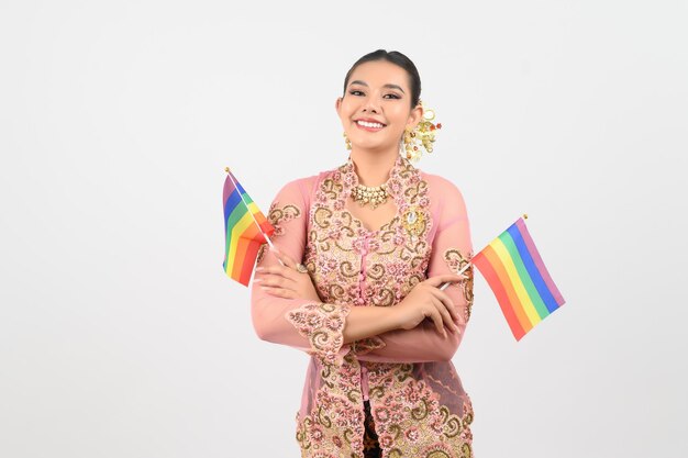 Young beautiful woman dress up in local culture in southern region with rainbow flag