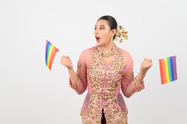 Young beautiful woman dress up in local culture in southern region with rainbow flag