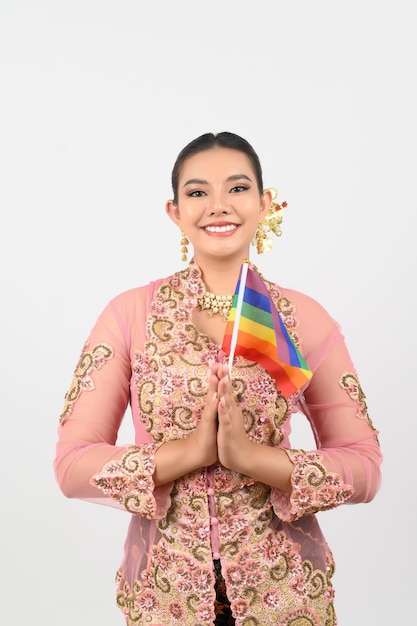 Young beautiful woman dress up in local culture in southern region with rainbow flag