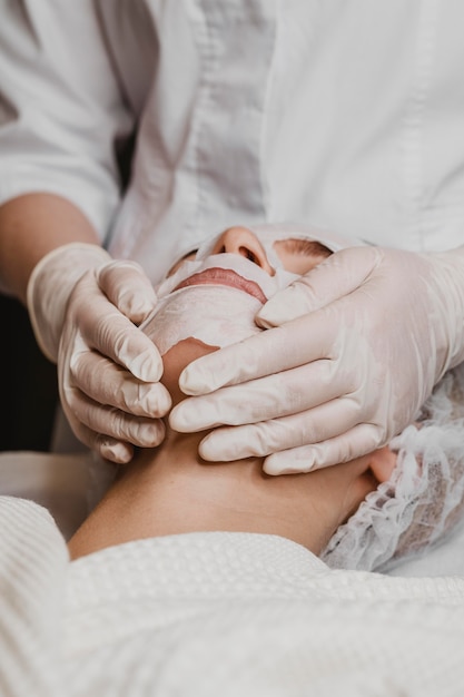 Young beautiful woman getting a skin mask treatment