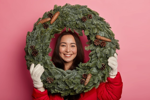 Free Photo young beautiful woman holding christmas decorations